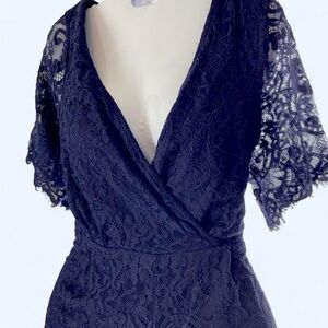 Navy blue lace romper with flutter sleeves and tie back. Size: L Blue Rain L